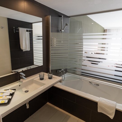 Baño moderno en 001 Hotels: Corporativa, con lavabo, ducha y bañera.