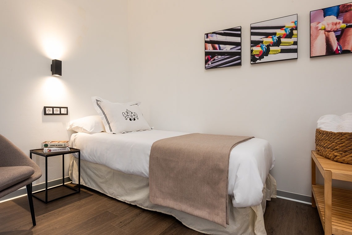 una habitación con una cama y tres cuadros en la pared