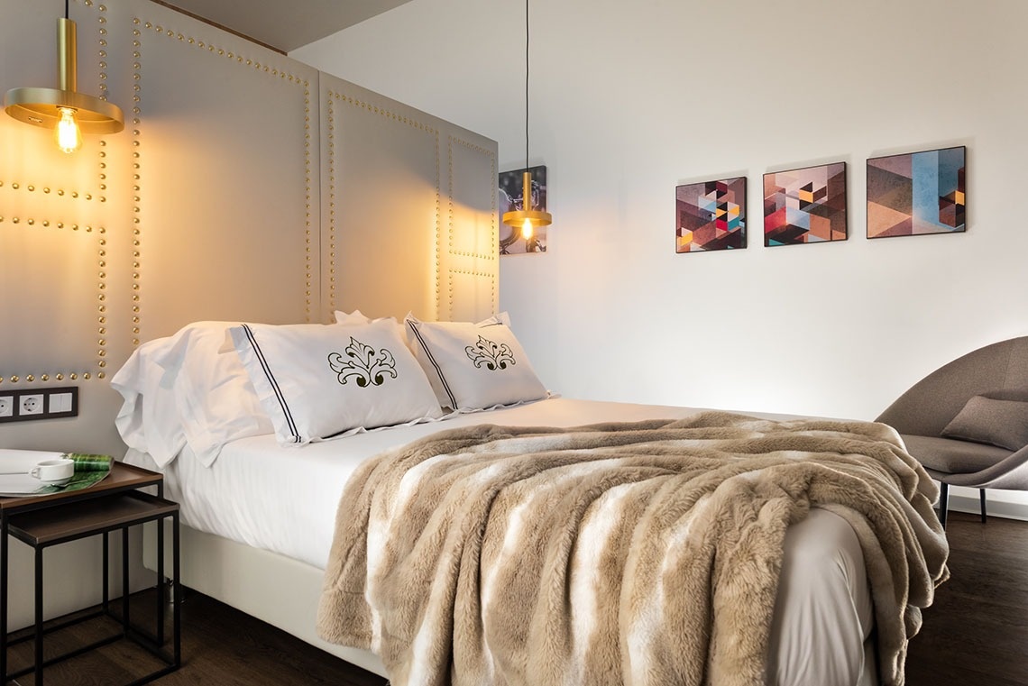 una habitación con una cama y tres cuadros en la pared