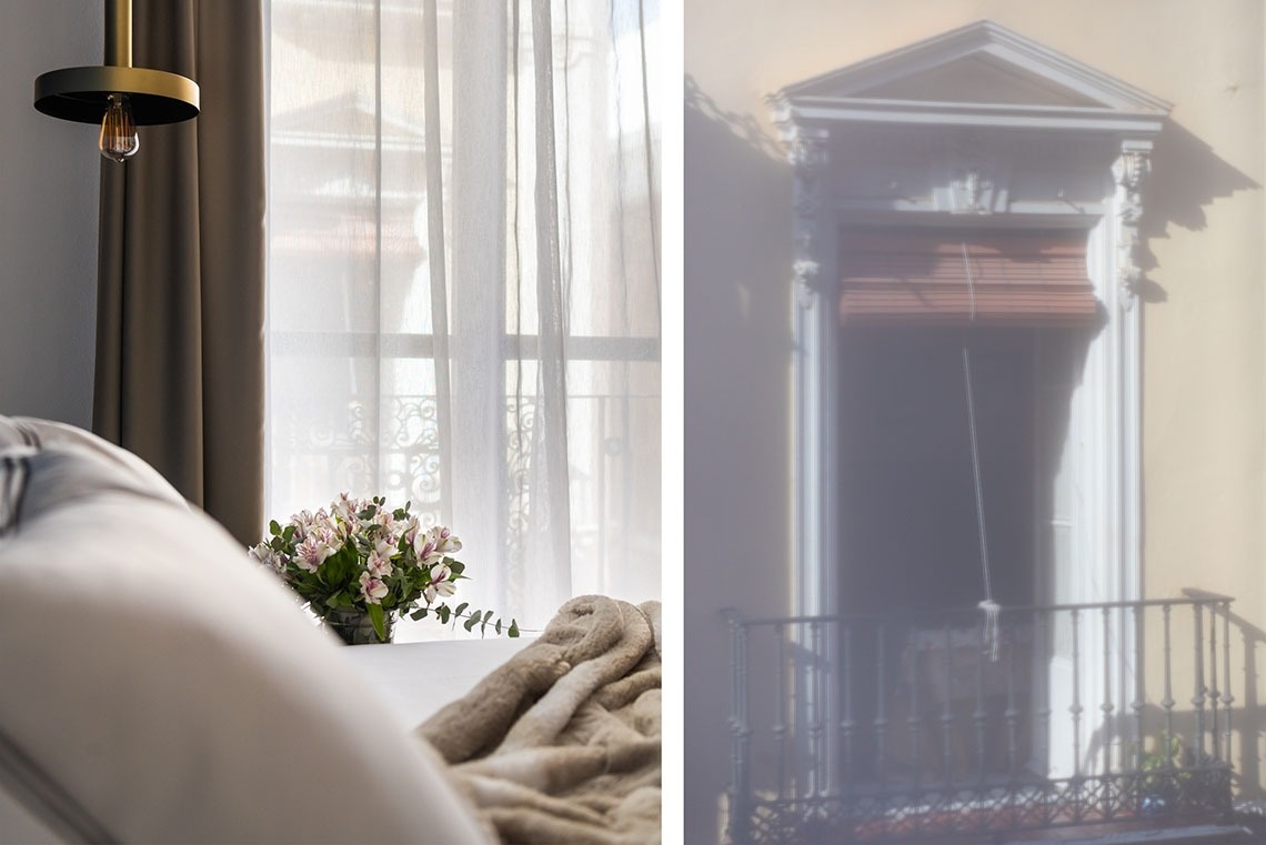 una habitación con una cama y una ventana con cortinas transparentes