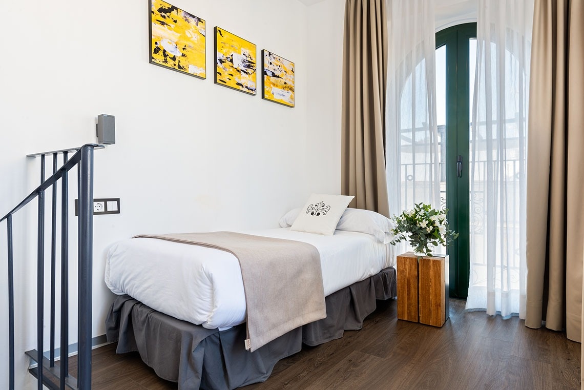 una habitación con una cama y tres cuadros en la pared