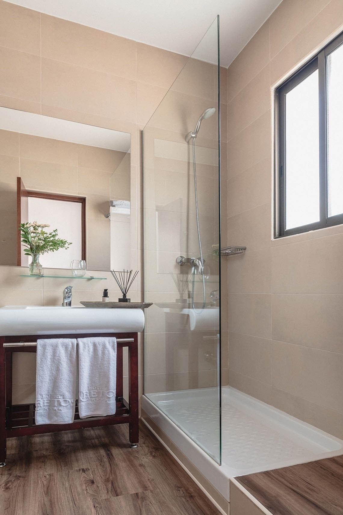 a bathroom with a walk in shower and a sink