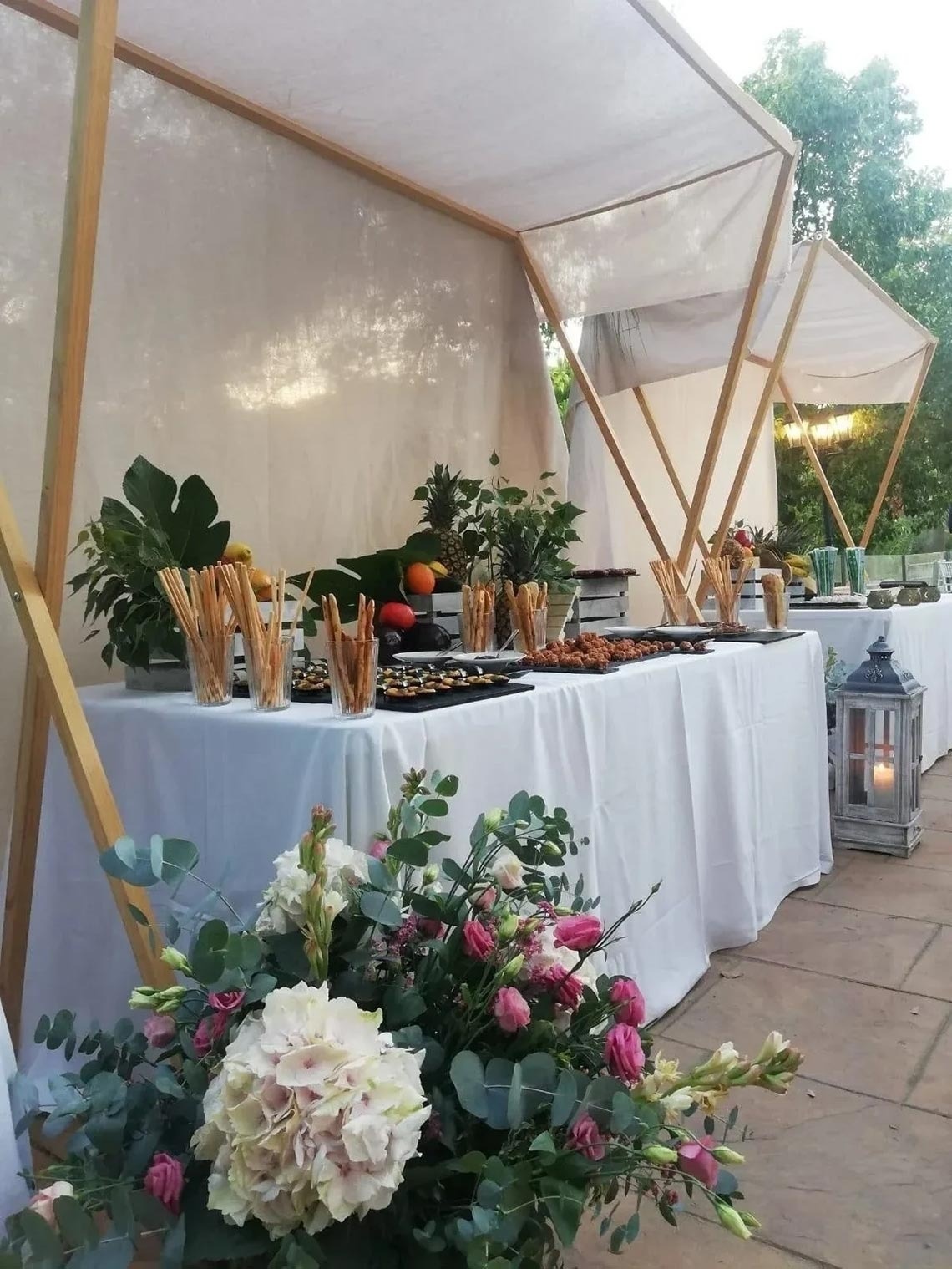 a buffet table with flowers in front of it