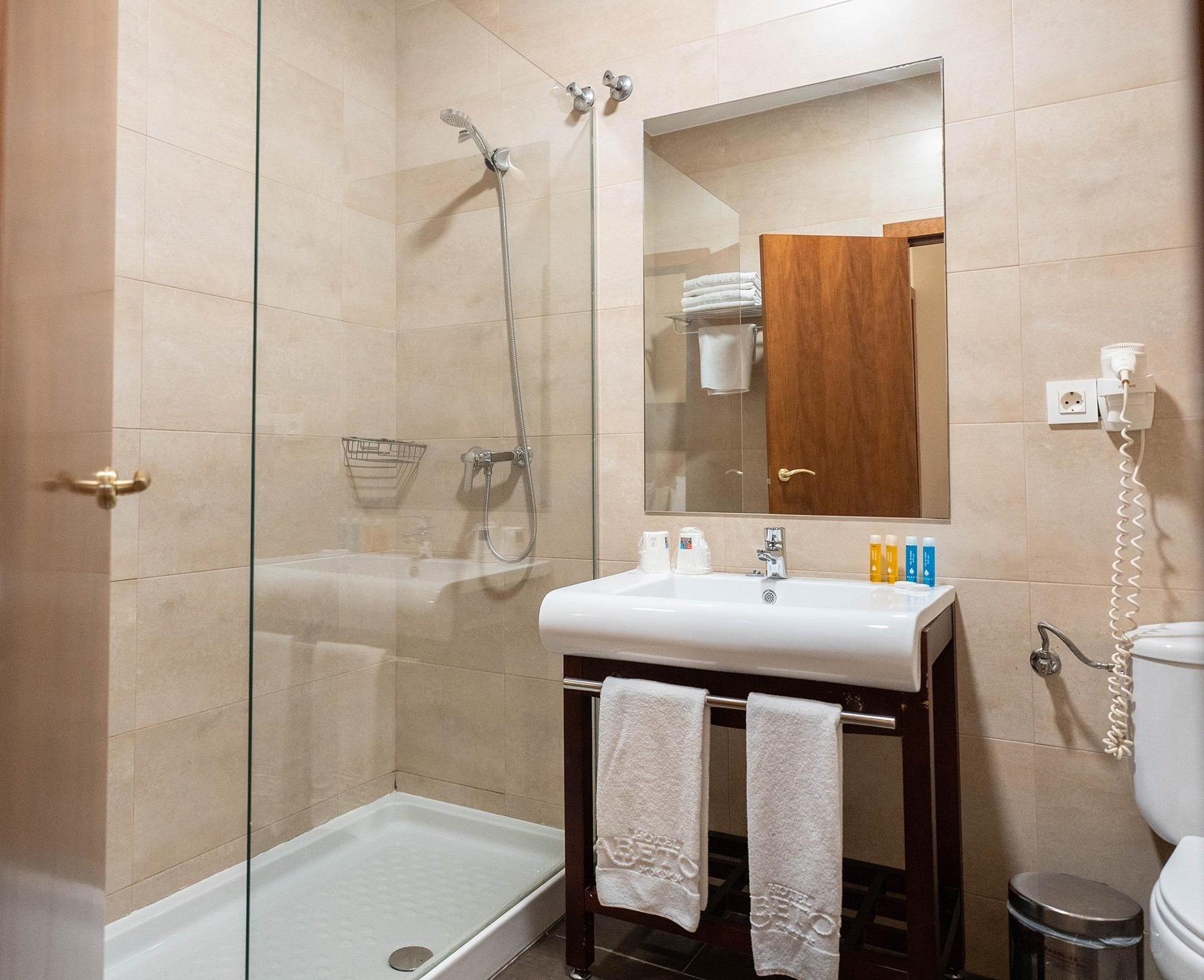 a bathroom with a sink a toilet and a shower