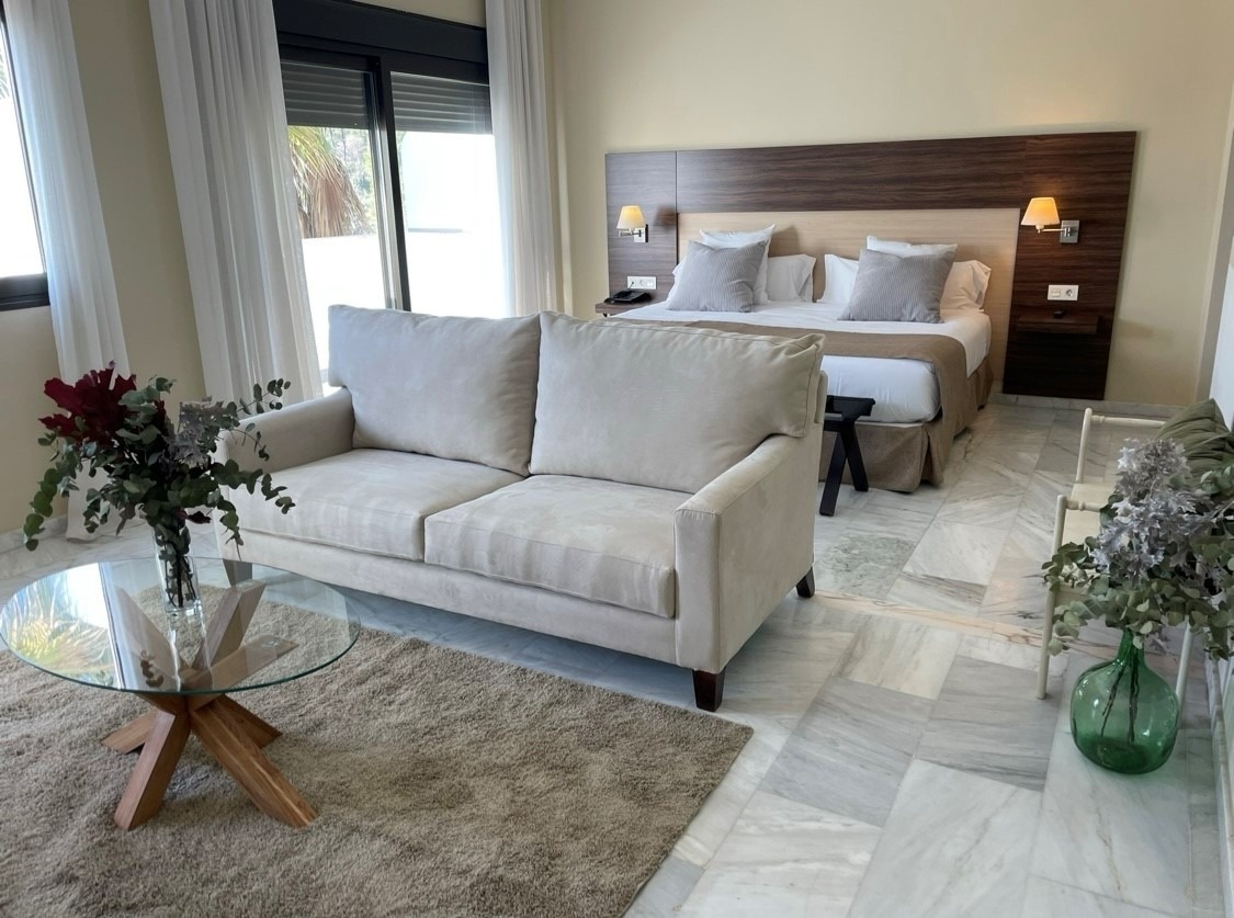 a hotel room with a couch and a bed