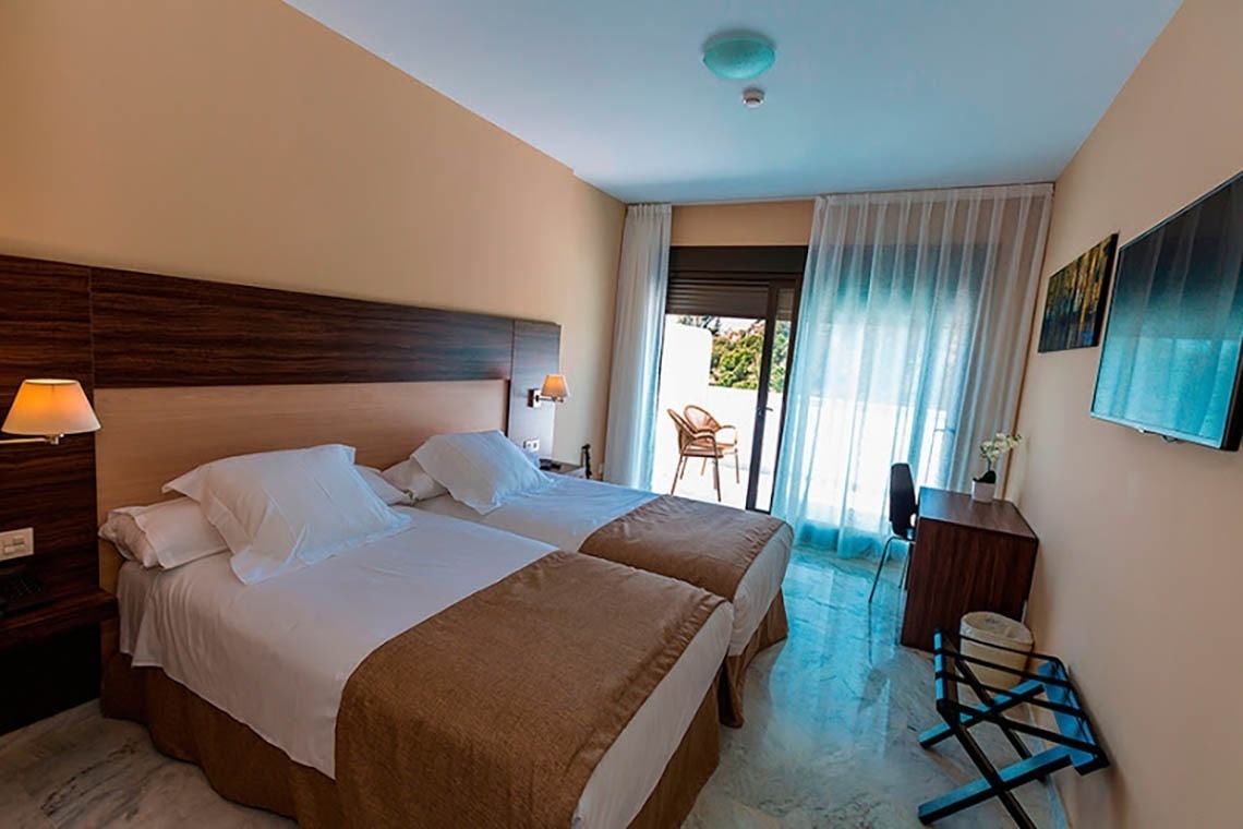 a hotel room with two beds and a television