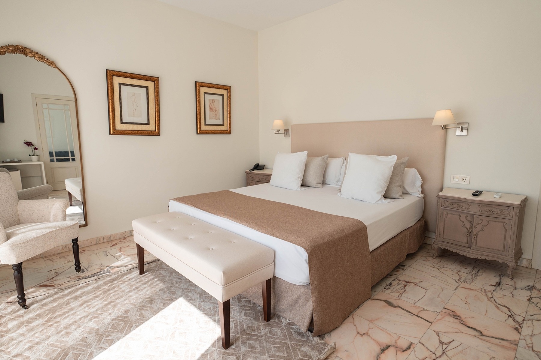 a hotel room with a large bed and a mirror