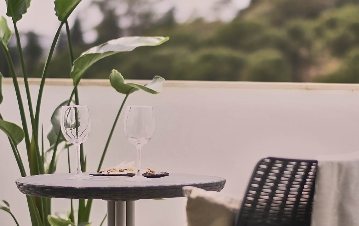 a table with two wine glasses and a plate of food on it