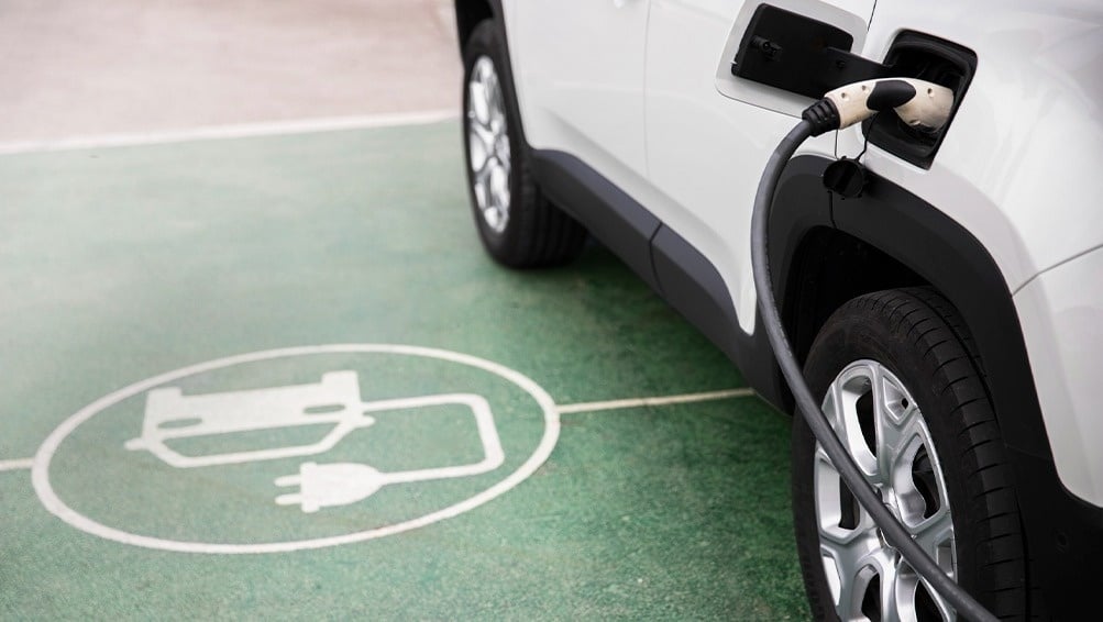 an electric car is being charged at a charging station
