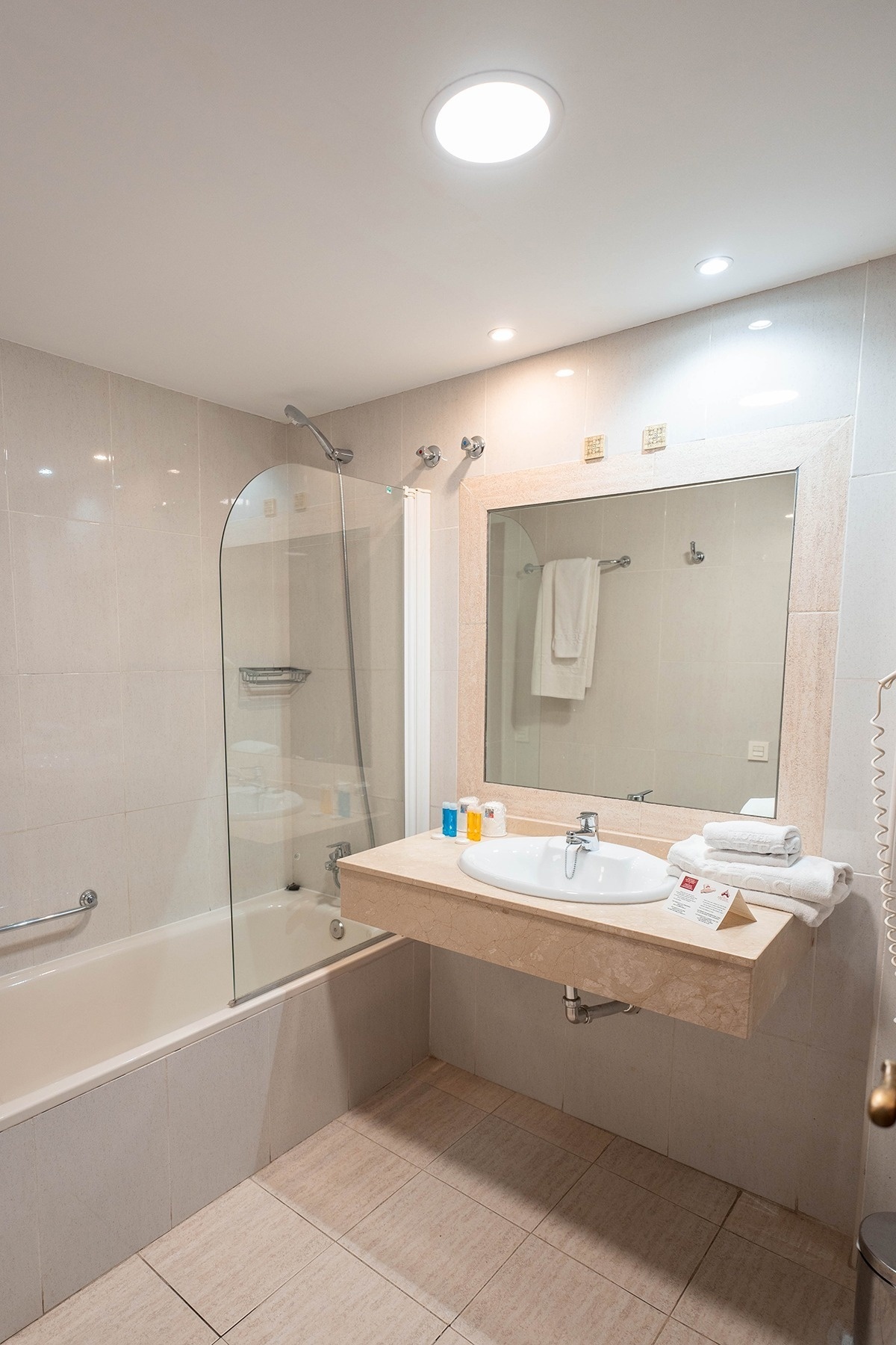 a bathroom with a sink a bathtub and a mirror