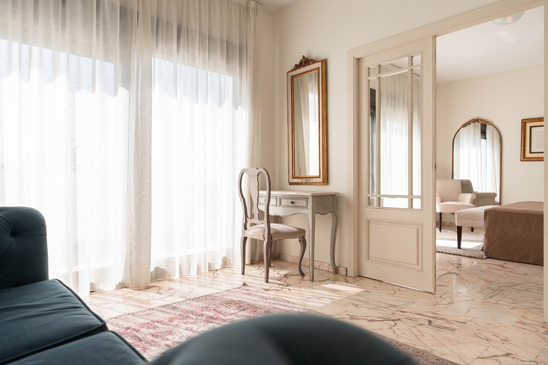 a room with a desk and a mirror on the wall