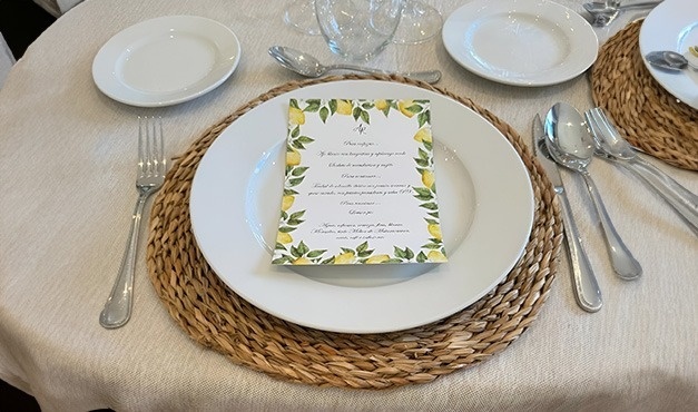 a plate with a menu on it sits on a table