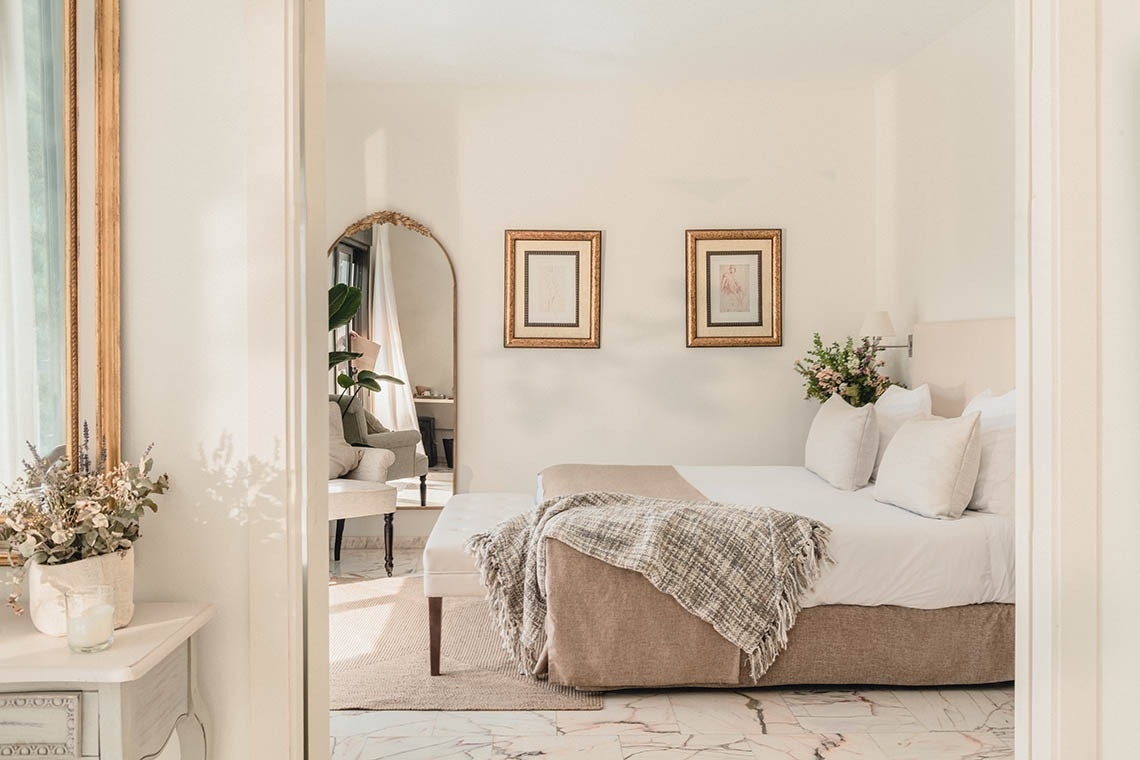 a bedroom with a large mirror and a bed