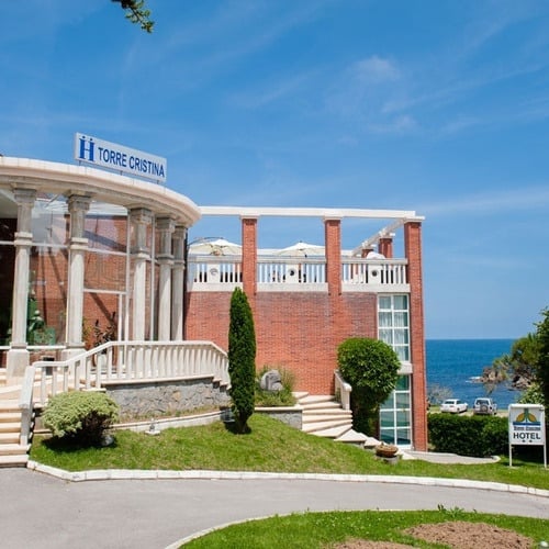 Hotel Torre Cristina with sea views, entrance, and brick facade.