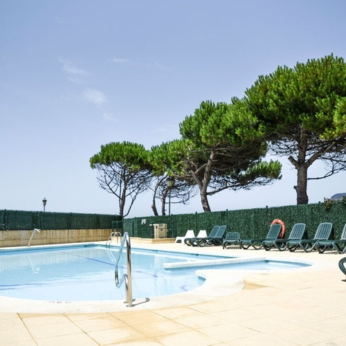 Blue swimming pool and sun loungers at Torre Cristina.