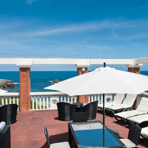 Torre Cristina terrace with sea views, lounge chairs, and seating area.