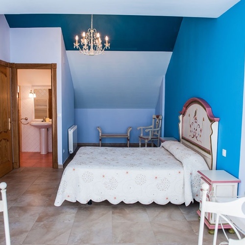 Dreamy bedroom at Torre Cristina, featuring a comfortable bed and en-suite bathroom.