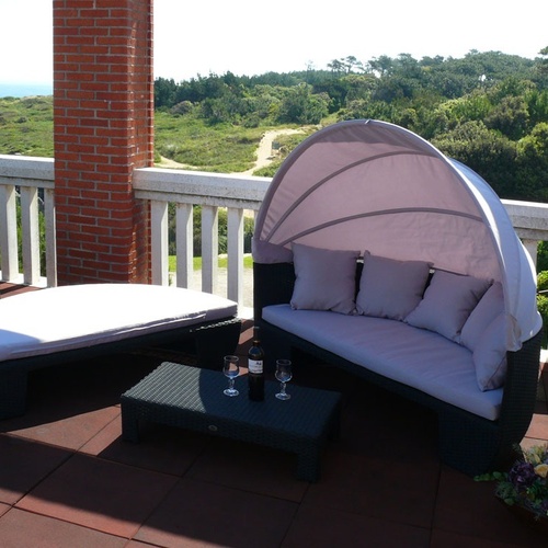Relax on Torre Cristina's plush outdoor sofas with sea and nature views.