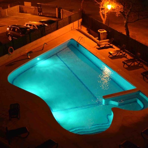 Illuminated pool at Torre Cristina: relax under the stars.