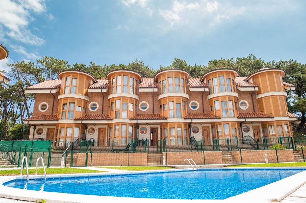 a large building with a swimming pool in front of it