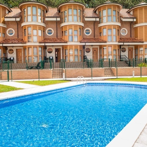 Sparkling pool next to Torre Cristina homes, an oasis of relaxation.