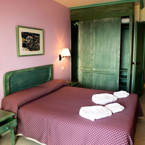 Double room at Torre Cristina featuring a comfortable bed and green wardrobe.