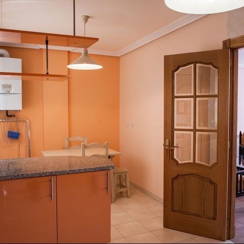Modern Torre Cristina kitchen with glass door and appliances.