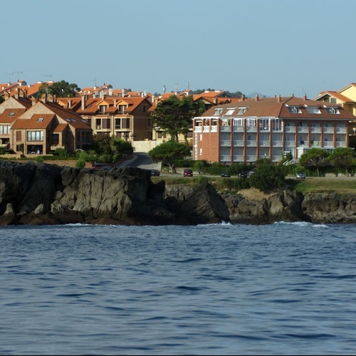 Hotel Torre Cristina: coastal architecture and sea views under a clear sky.