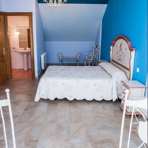 Cozy room at Torre Cristina featuring a comfortable bed and blue decor.