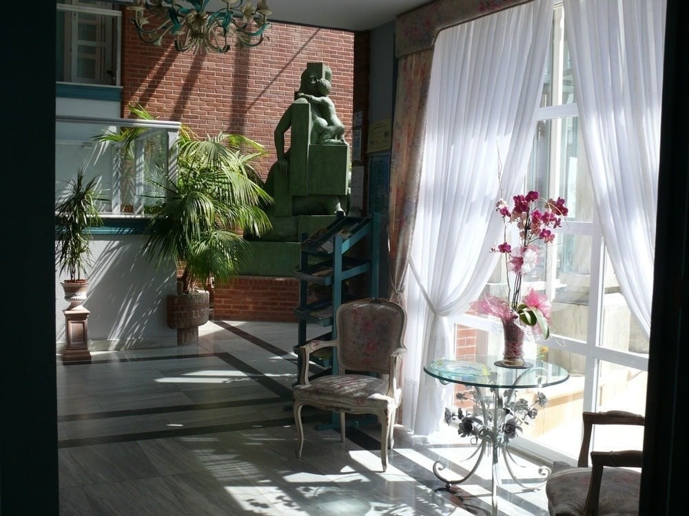 un edificio rojo y blanco con balcones está junto a un océano