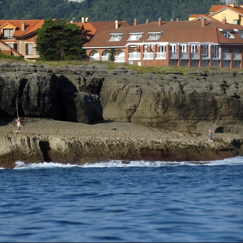 Ocean views and cliffside fishing near Torre Cristina Hotel.