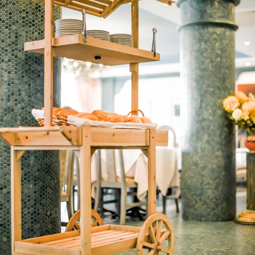 Wooden cart at Torre Cristina with plates and bread for buffet.