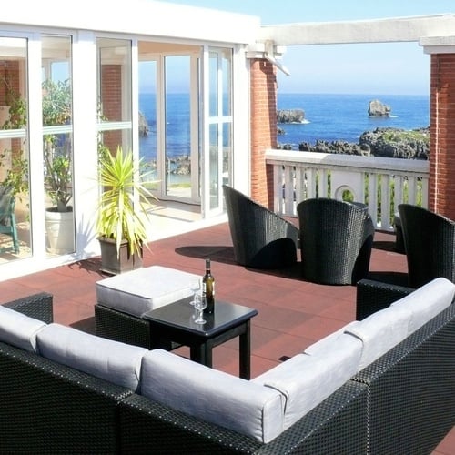 Torre Cristina terrace with sea views and outdoor seating.