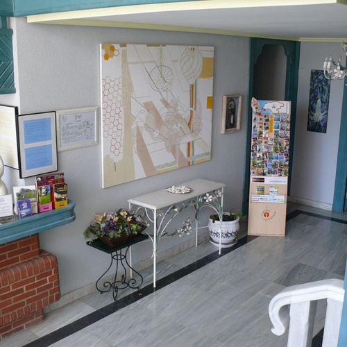 Welcoming reception area at Torre Cristina with modern art and elegant furnishings.