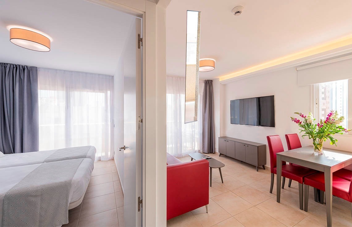 a hotel room with two beds and a table and chairs