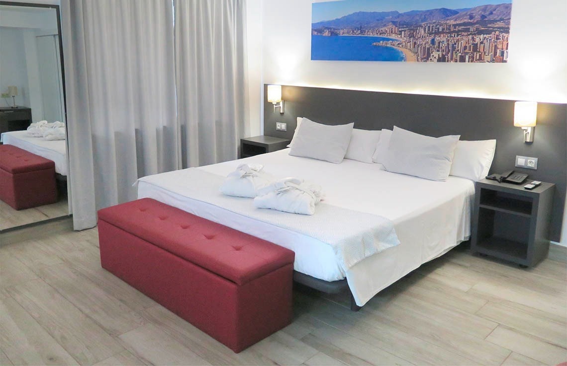 a hotel room with a large bed and a picture on the wall