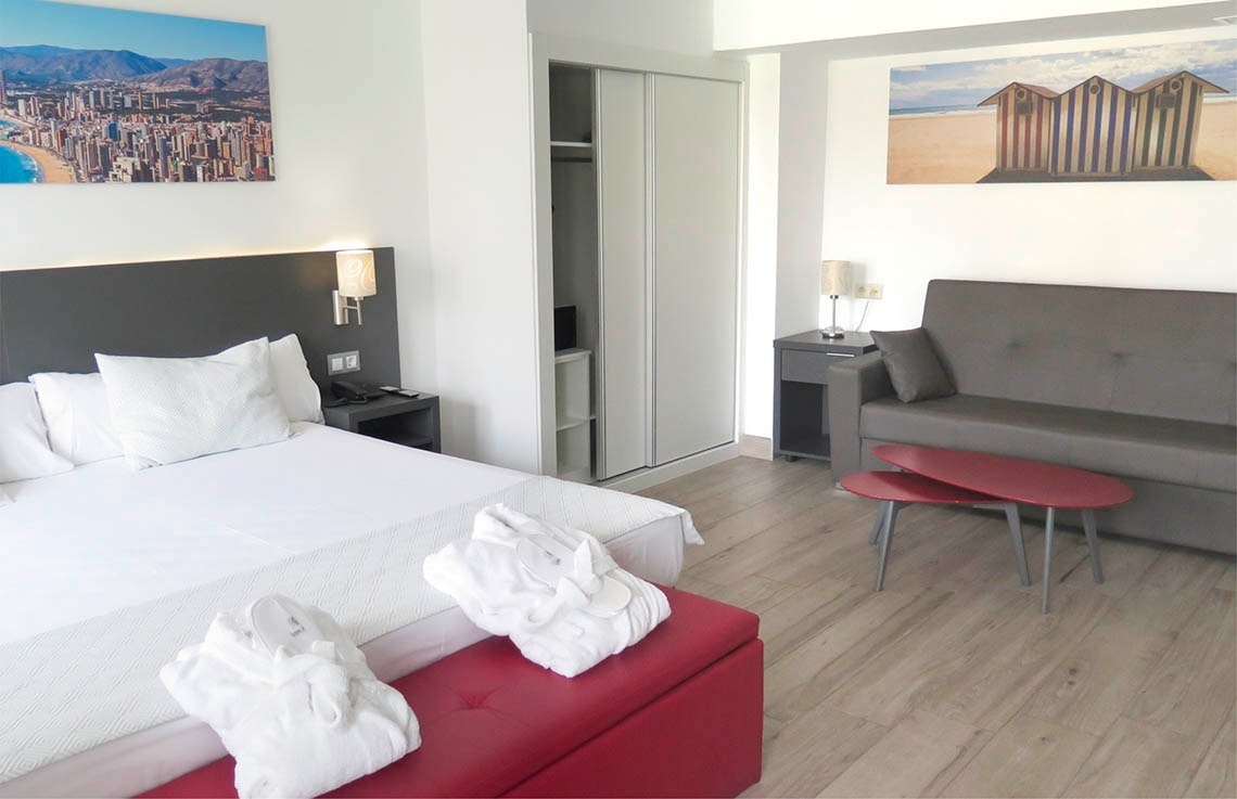 a hotel room with a large bed and a couch
