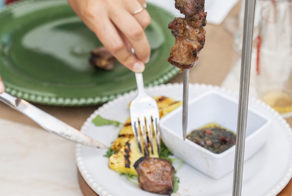 a person is dipping a piece of bread into a bowl of food