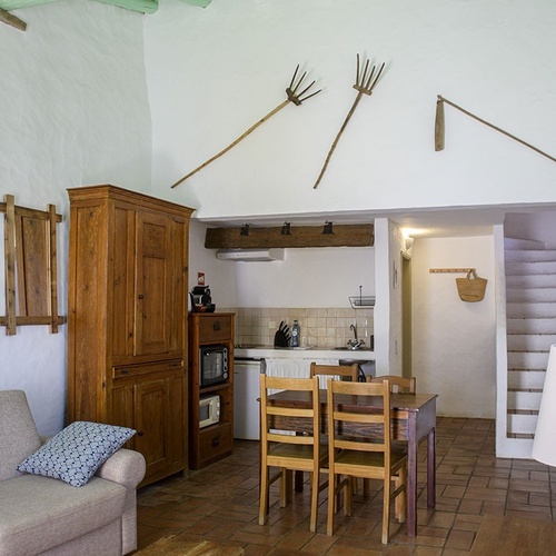 a living room with a couch and a table and chairs