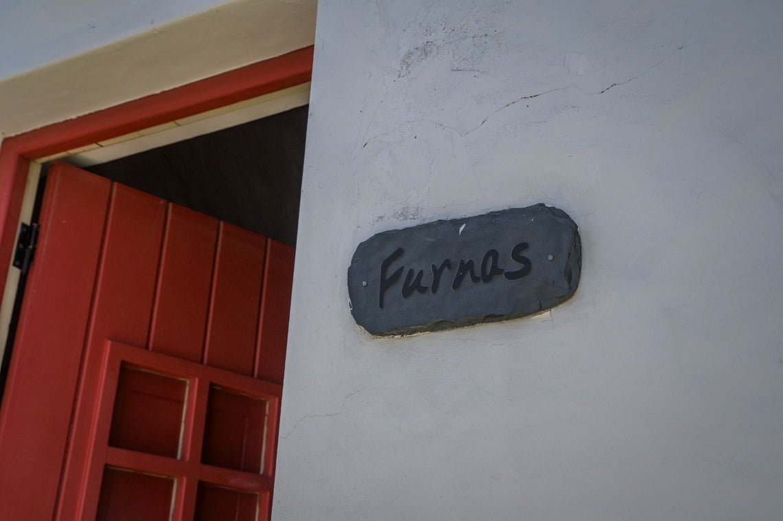 a bedroom with two beds and a clothes rack
