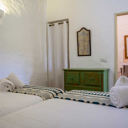 Aldeia da Pedralva bedroom with two twin beds and en-suite bathroom access.