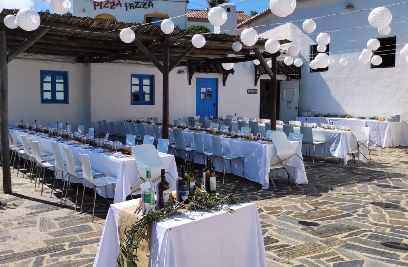 tables and chairs are set up in front of a pizza pazza restaurant