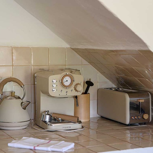 Retro kitchen appliances at Aldeia da Pedralva hotel: kettle, coffee maker, and toaster.