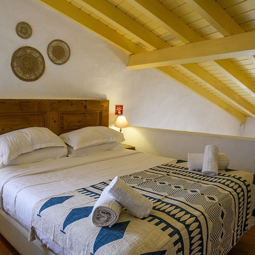 a bed with a blue and white blanket on it