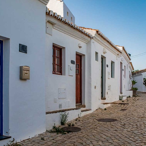 Charming white houses and cobblestone street in Aldeia da Pedralva.