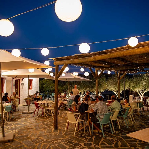 Aldeia da Pedralva: Outdoor dining with paper lanterns and white umbrellas under a starry night.