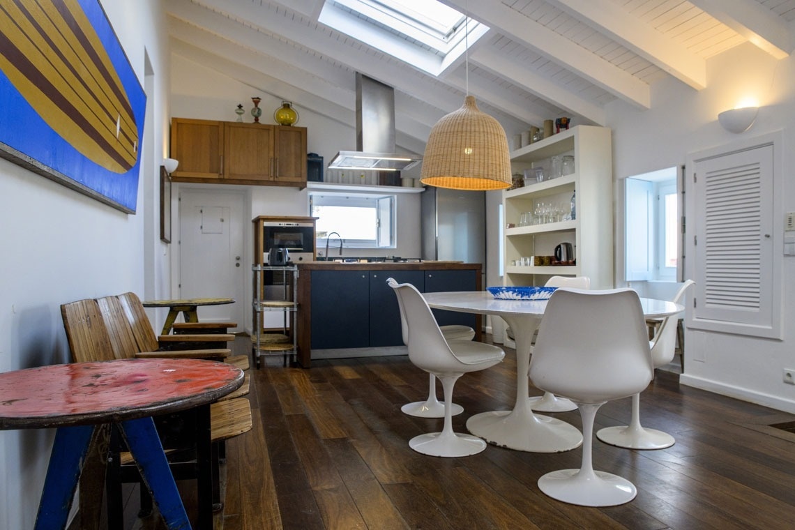 a table and chairs outside of a white building