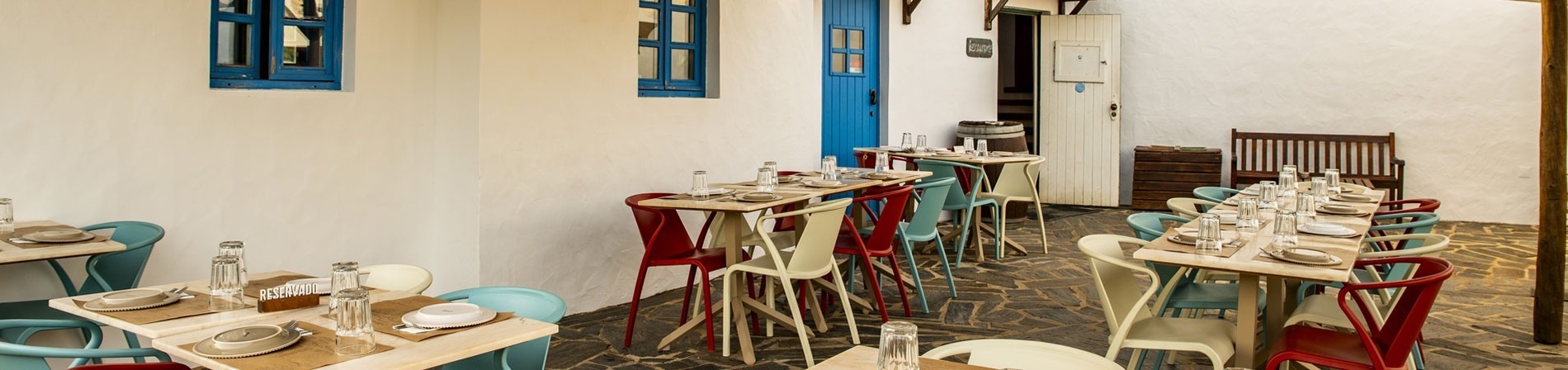 a restaurant with tables and chairs and a blue door