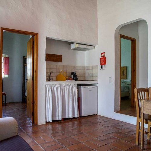Cozy kitchen and dining area at Aldeia da Pedralva hotel.