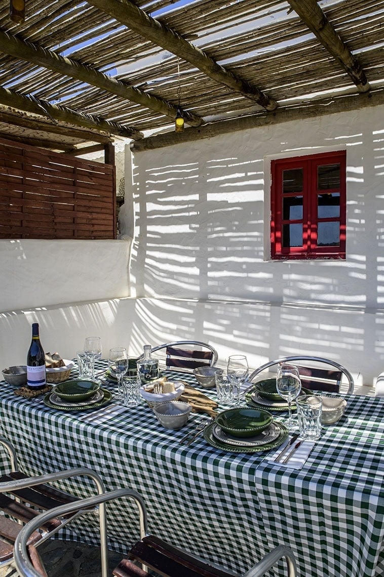 a white building with a red door and a sign that says cottage